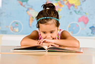 little girl looking at open book